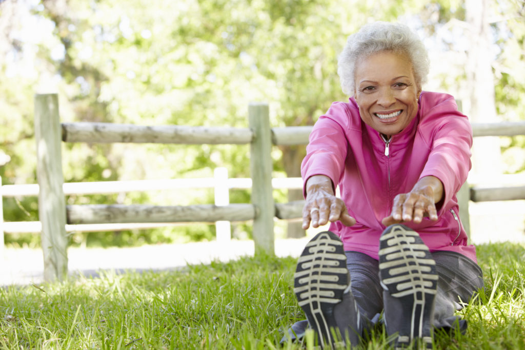 Elderly woman staying spry and healthy by stretching