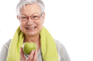 This elderly woman holding an apple demonstrates the need for proper nourishment while aging